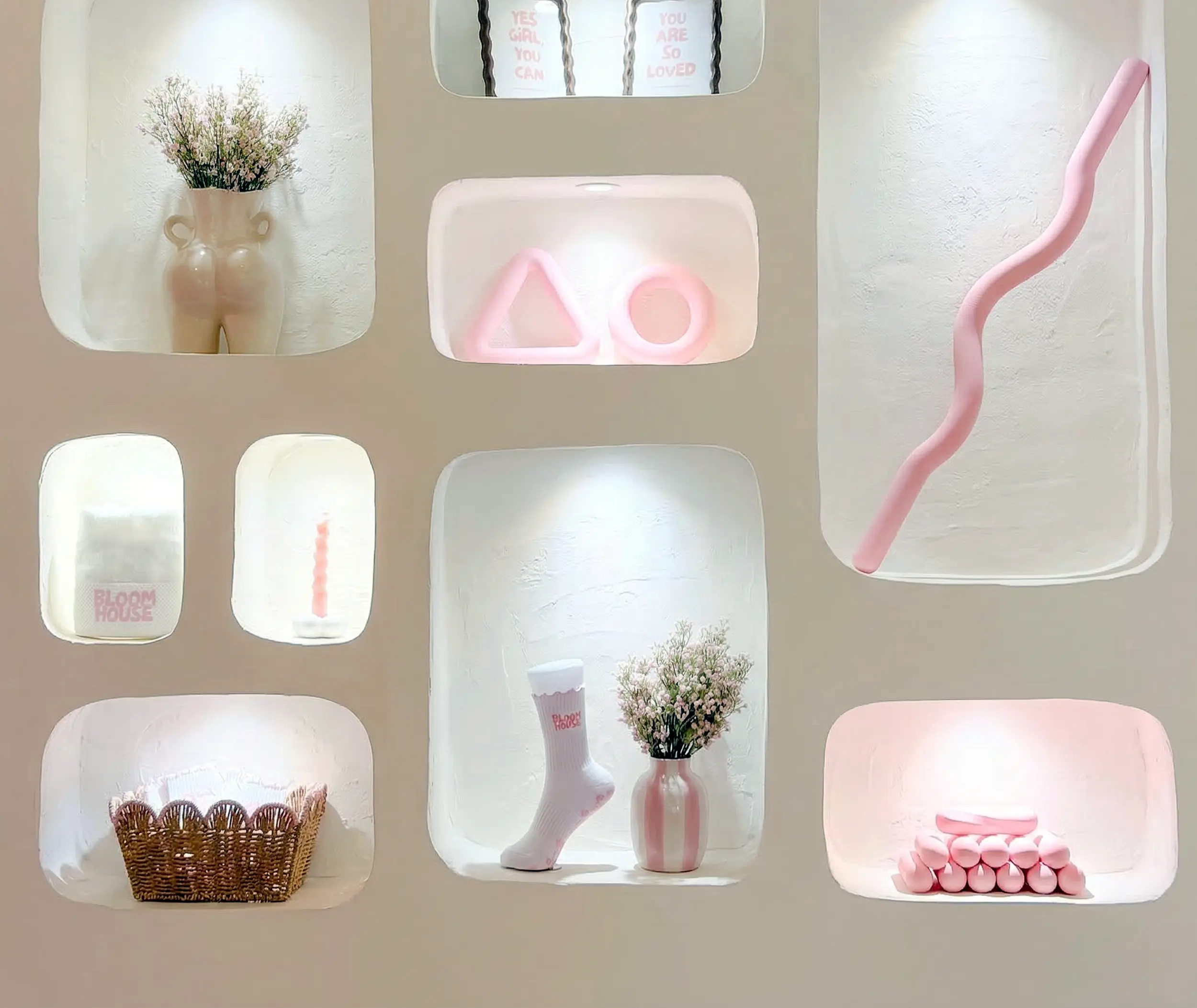 The wall of niches at Bloomhouse with grip socks, flowers and pink Pilates props